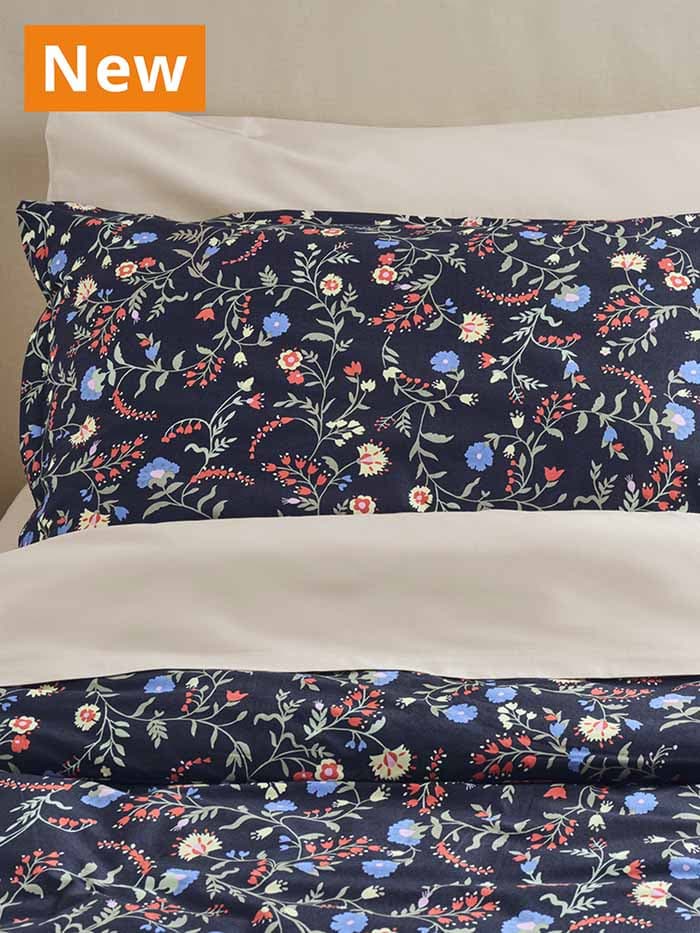 NEW IKEA product. BRUDKRUSBÄR duvet set, black/floral pattern on a queen sized bed. 100% organic cotton certified by GOTS - the Global Organic Textile Standard.