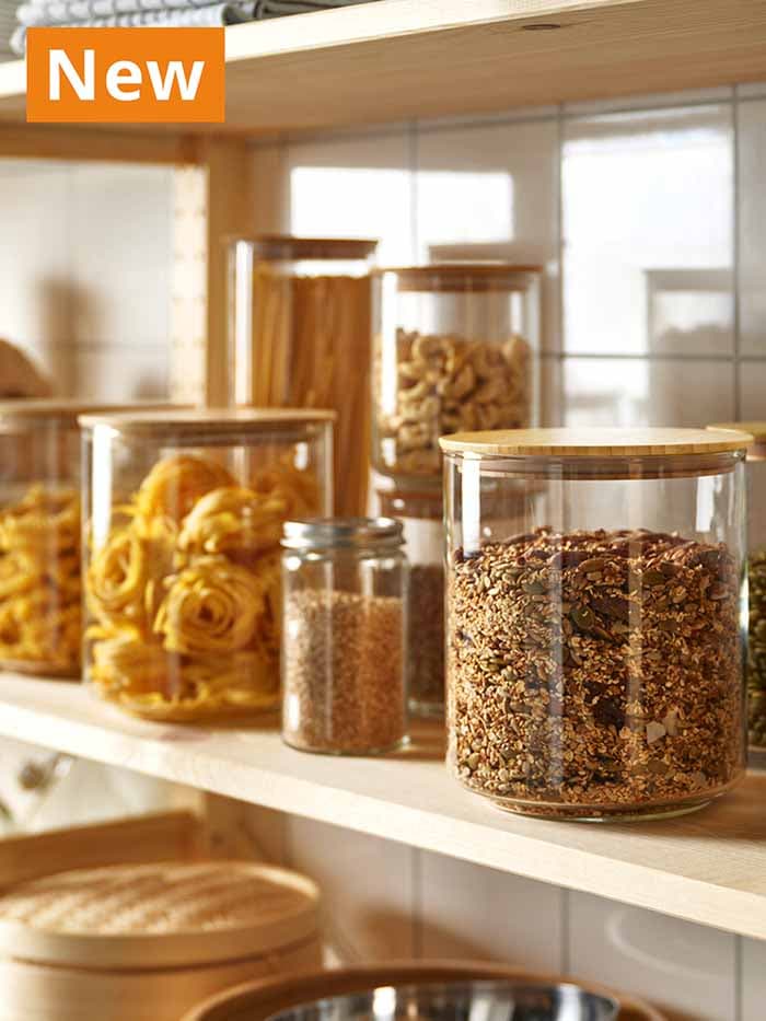 NEW IKEA product. EKLATANT, jars with lid 2.3 l clear glass/bamboo, on kitchen shelf, filled with pasta and other dried foods.