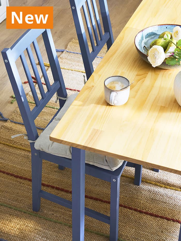 NEW IKEA product. Light brown stained/blue stained pine PINNTORP dining table with blue PINNTORP dining chair in a dining area.