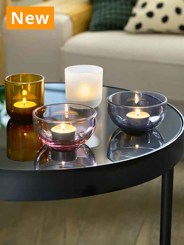 NEW IKEA product. TALLTITA tealight holder set of 2, grey/frosted glass on coffee table in the living room, filled with GLIMMA tealights.