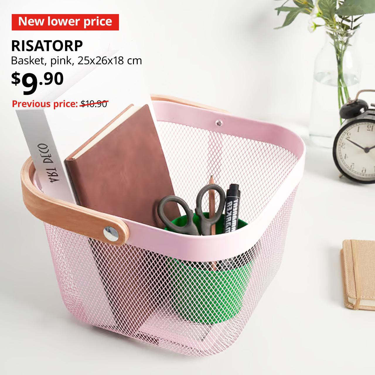 New lower price tag. Pink RISATORP basket filled with stationery and books, $9.90. Previous price: $10.90