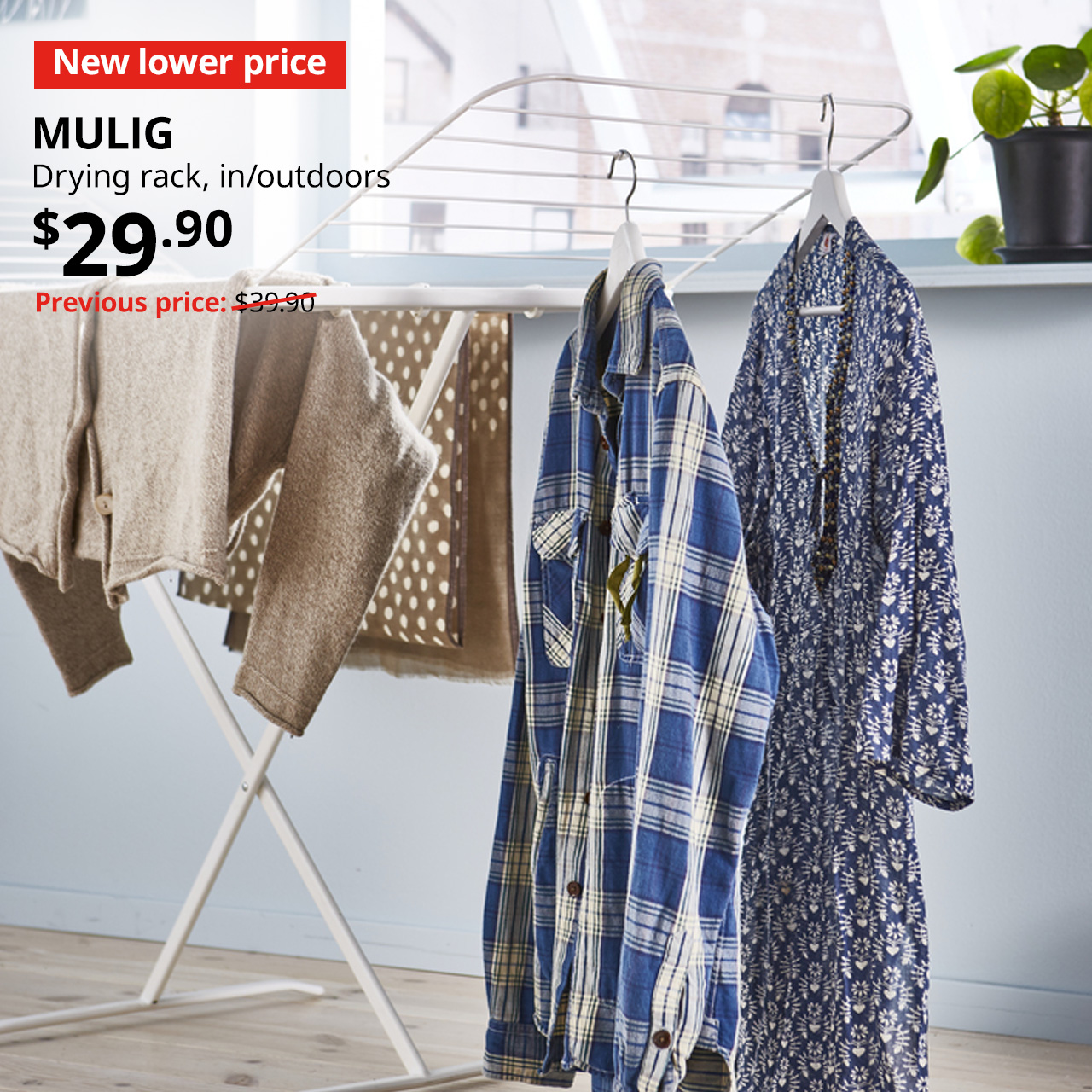 New lower price tag. White MULIG drying rack filled with laundry, $29.90. Previous price: $39.90