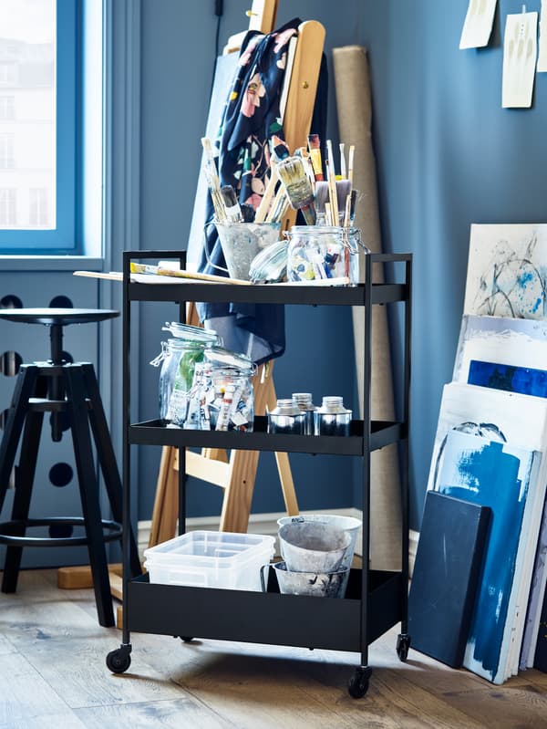NISSAFORS trolley in black, plastic storage boxes and a black bar stool.