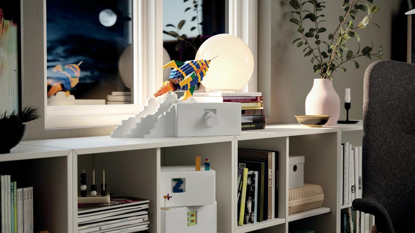 月夜の窓辺に、カラフルなロケットのブロックデコレーションと本、観葉植物を並べたイケアのリビング収納シェルフ