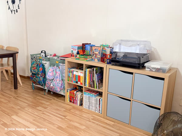 Oak veneer KALLAX bookshelves and trolleys filled with books in a 3-room HDB flat in Bishan, Singapore. This is before the makeover.