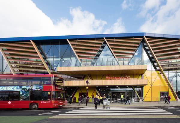 Obchodní dům IKEA Greenwich v Londýně, fasáda ze dřeva a skla, červený dvoupatrový autobut před obchodem