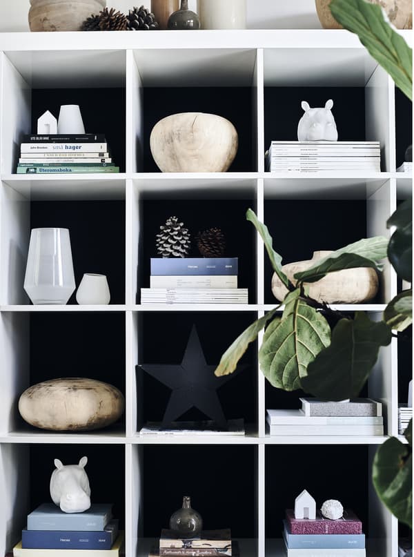 Objects and magazines displayed on a storage unit.