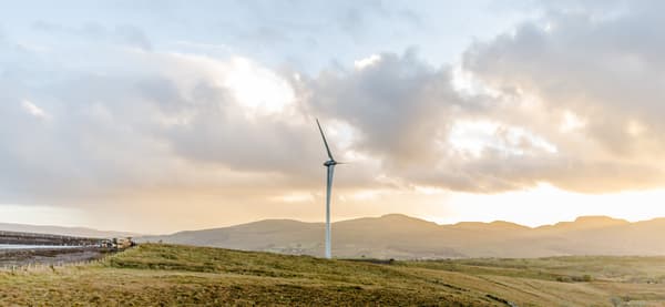 Open landscape with a wind turbine in the middle