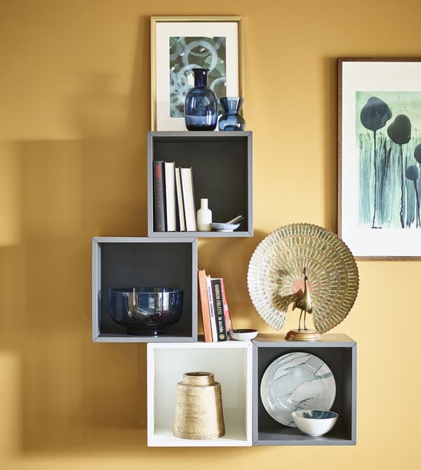 Open wall cabinets display decorative items and artwork.