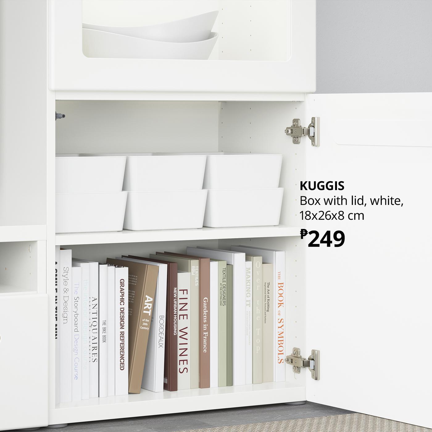 Open white cabinet with books, binders, and white storage boxes; product label reads “KUGGIS” box with lid, 18×26×8 cm, ₱249. Clean, orderly look.