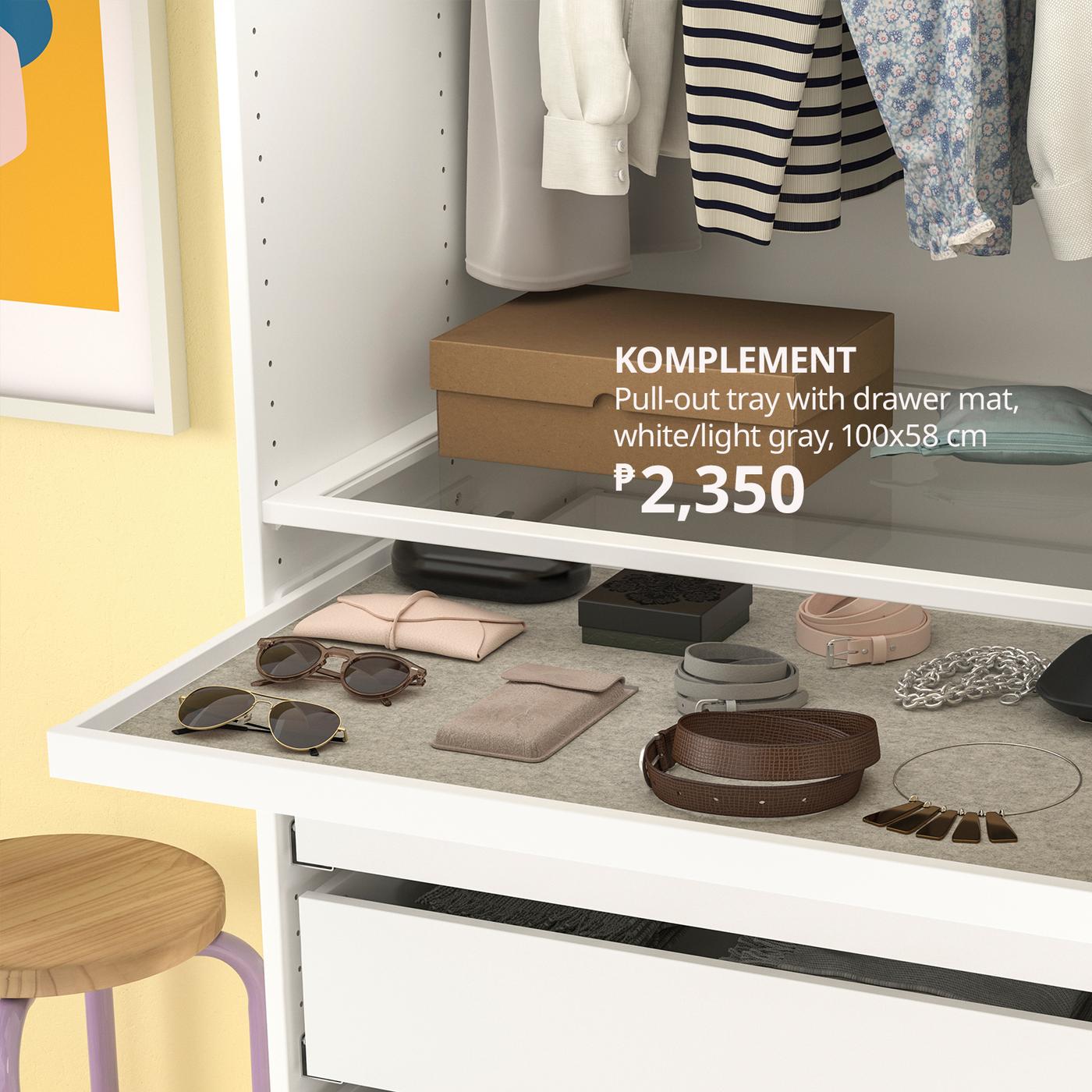 Open white wardrobe drawer organizer holding sunglasses, belts, jewelry, and pouches; hanging clothes above. KOMPLEMENT tray, ₱2,350.
