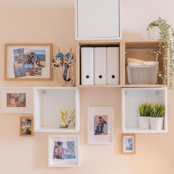 Open wooden drawers under TV unit storing board games and toys.