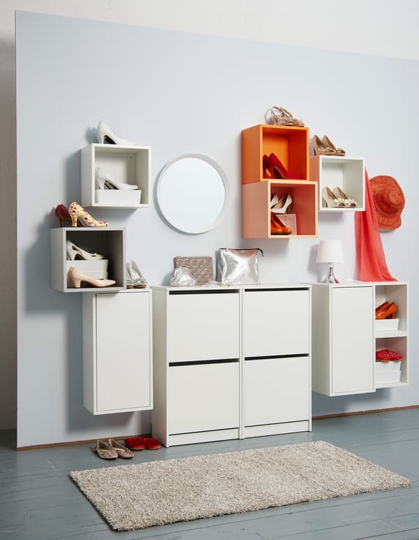 Orange and white open storage displays pairs of high heels, while closed sotrage stores other pairs.