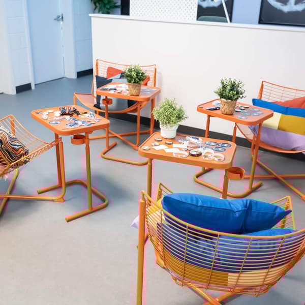 Orange IKEA furniture and tables in a room.