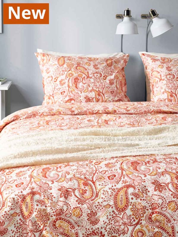 Orange/white RODGERSIA matching duvet cover and pillowcase on the bed.
