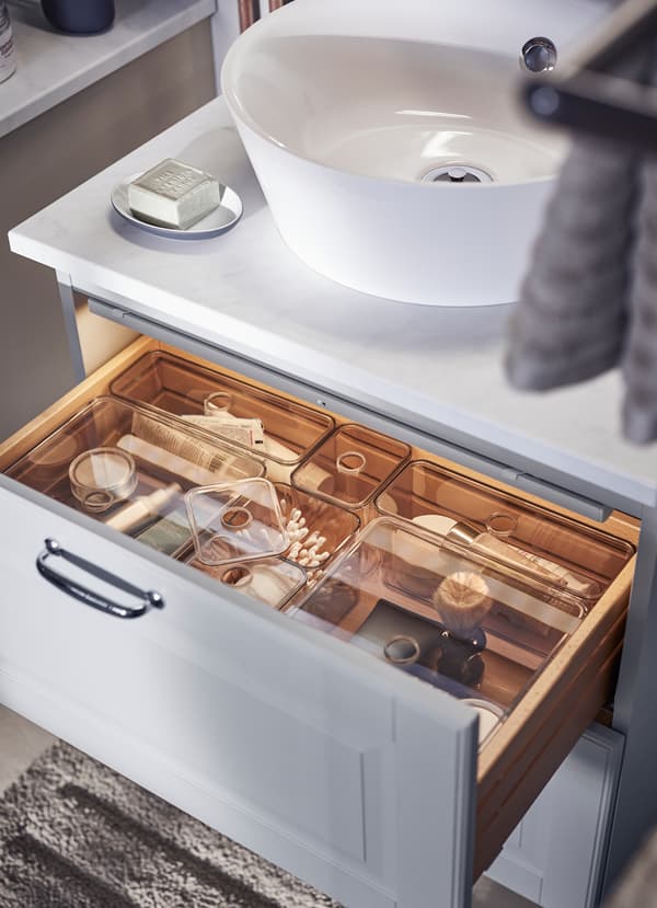 Organise your bathroom drawers with transparent GODMORGON organiser boxes. The clear plastic lids have a small whole in the center for ventiliation and so you can open the box with just a finger.