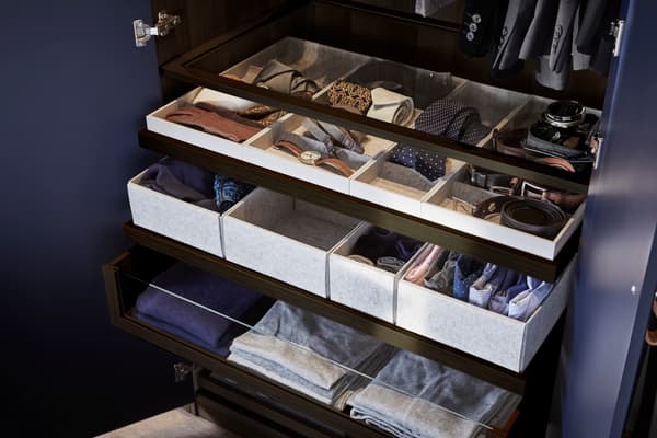Organise your wardrobe by colour and use boxes for clothing