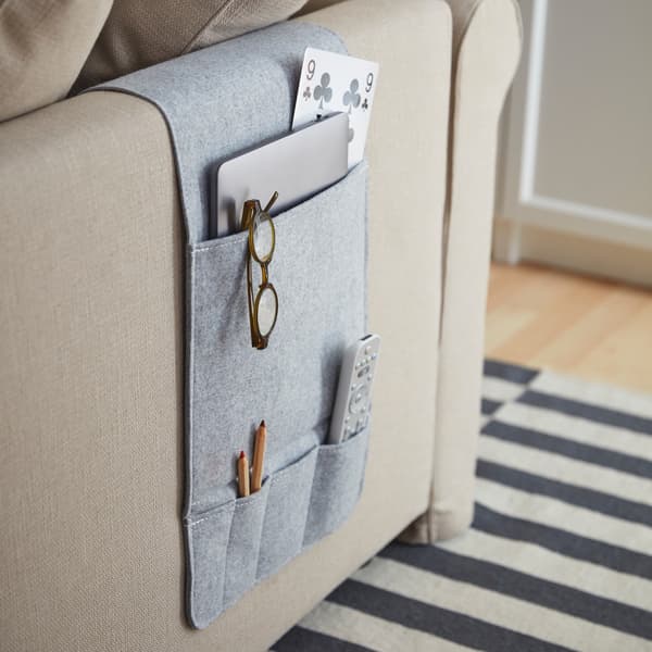 Organizer with pockets for armrests of sofas, doors or bed sides.
