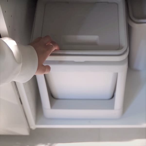 Osoba otwierająca szufladę z koszami HÅLLBAR.