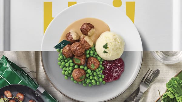 Overhead view of a plate with roasted meatballs, peas, mashed potatoes, gravy, and cranberry sauce.