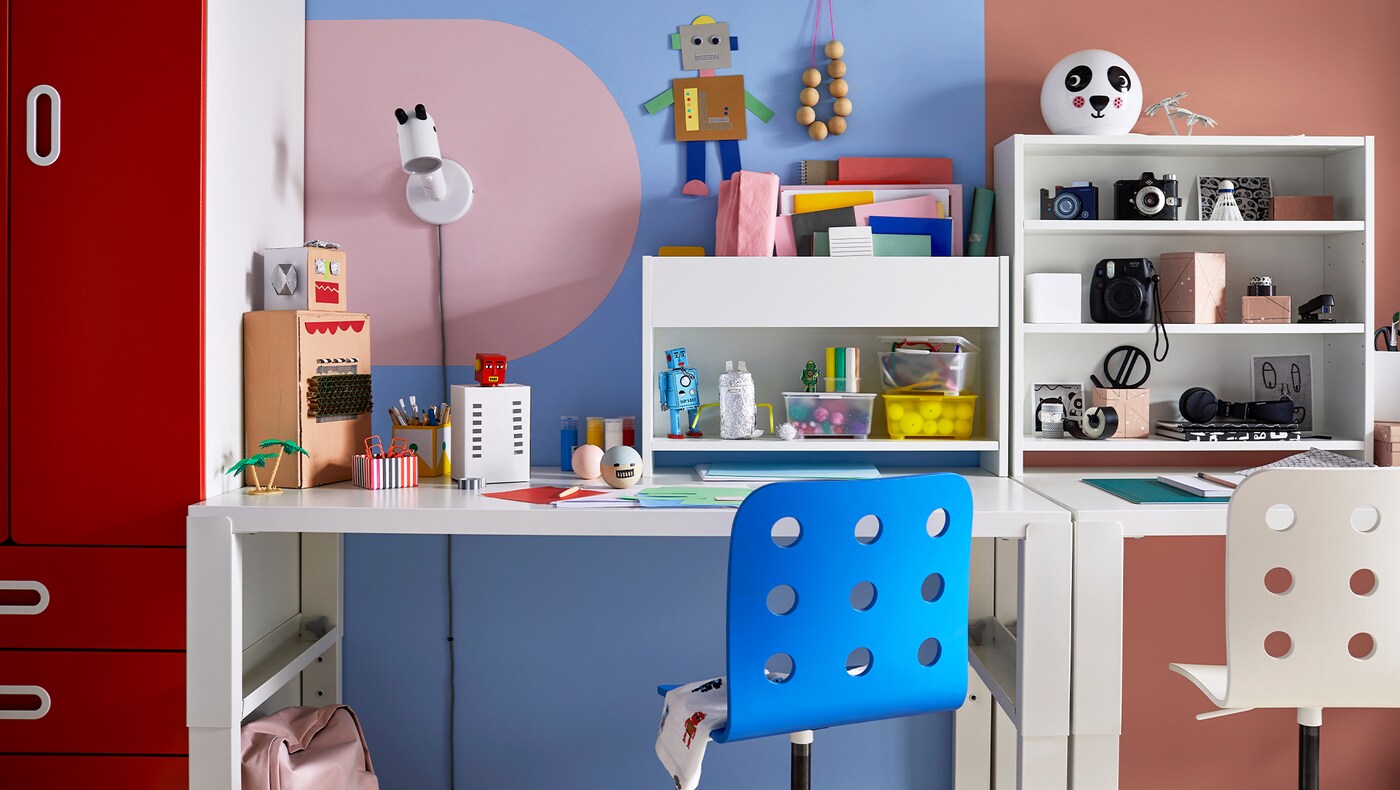 PÅHL white desk with add-on unit and a blue chair.