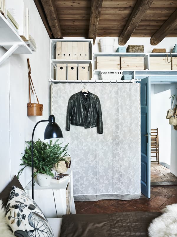 Pale fabric and lace draped over an open wardrobe.