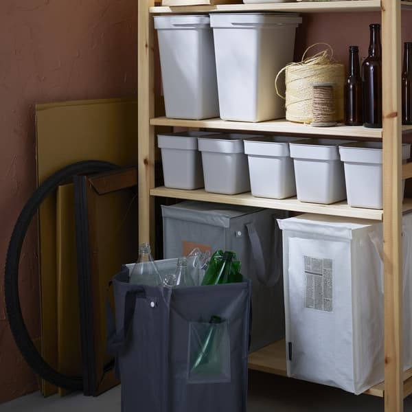 Pantry shelving unit with bins and containers for sorting household waste and recyclables.				