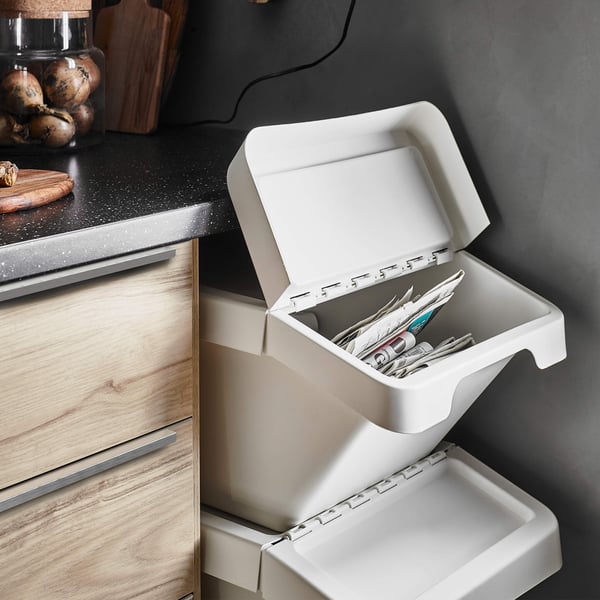 Paper and other items in an organized recycling bin