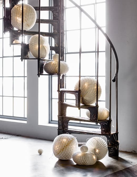Paper decorations with lights spilling down a staircase