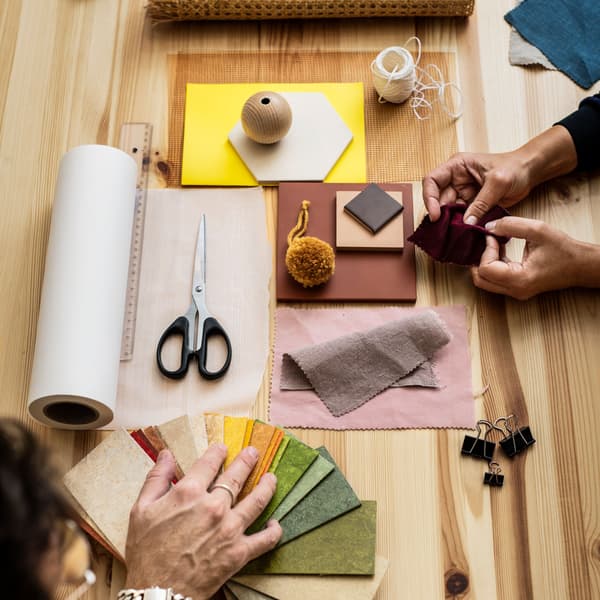 Paper with sketch, scissors and pencils, depicting workshops and events organised by IKEA Family.
