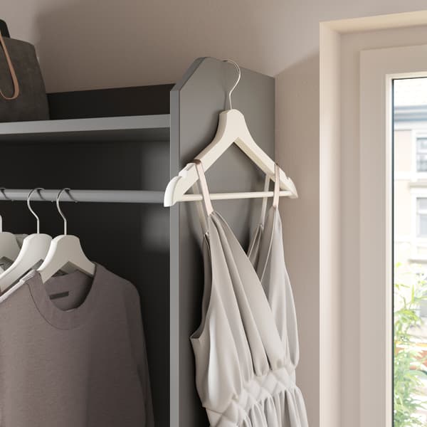 Part of a grey HAUGA open wardrobe, shirts on hangers in a row, a single hanger with a dress hanging from the top edge.