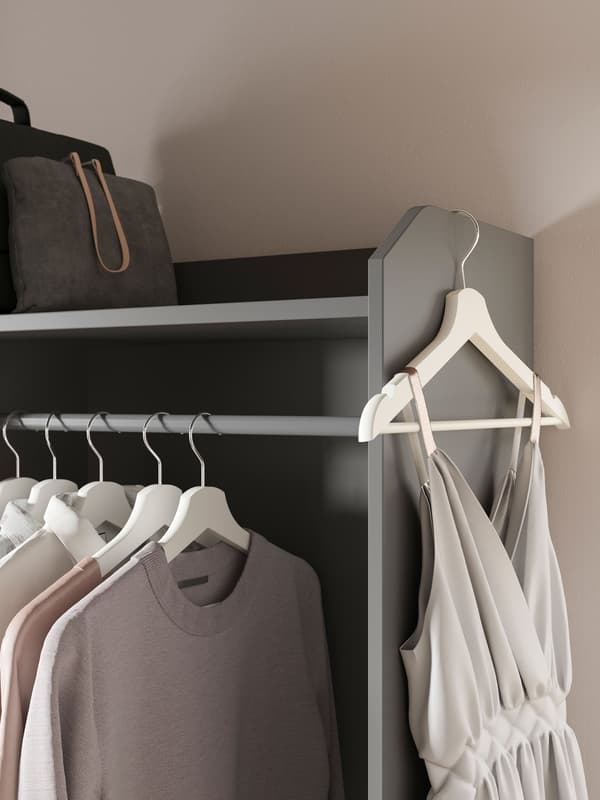Part of a grey HAUGA open wardrobe,with  shirts on hangers in a row, and a single hanger with a dress hanging from the top edge.