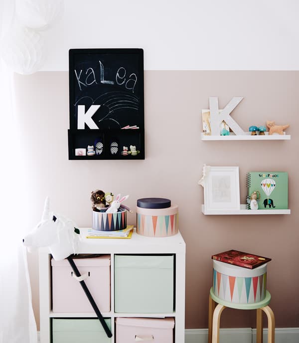 Pastel-coloured child’s bedroom with storage.
