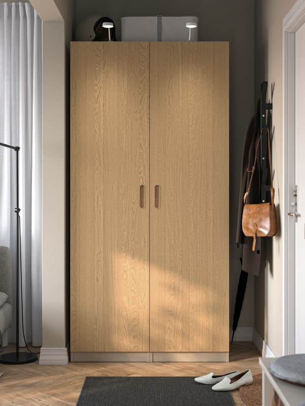 PAX wardrobes with TONSTAD doors and frames in the bedroom area. 