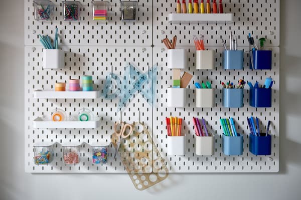 pegboard with containers and shelves to store office supplies