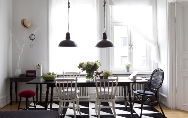 Pendant lights hang over a large dining table.