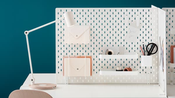 perforated plate on the wall with various storage compartments