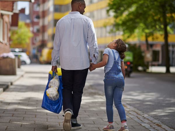 Person and child walking down an urban street