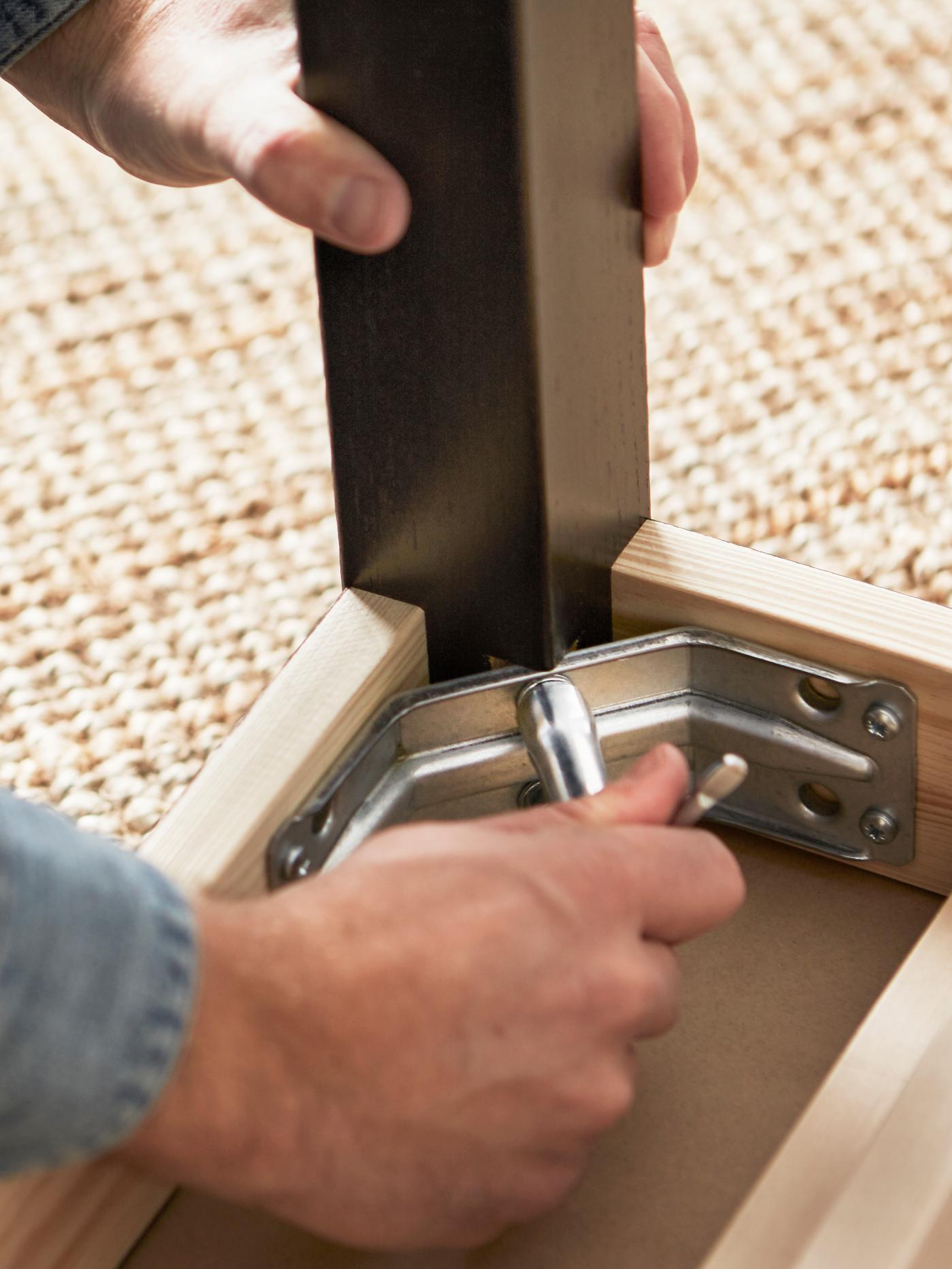 person assembling furniture