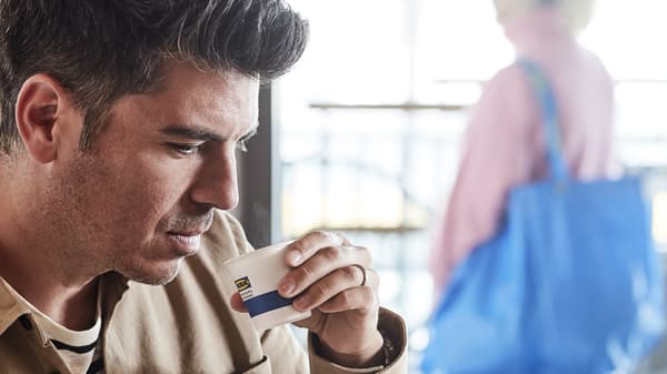 Person drinking an ikea small coffee
