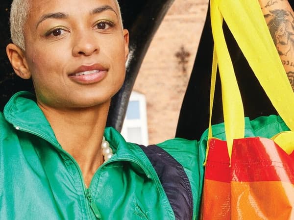 Person holding a rainbow bag