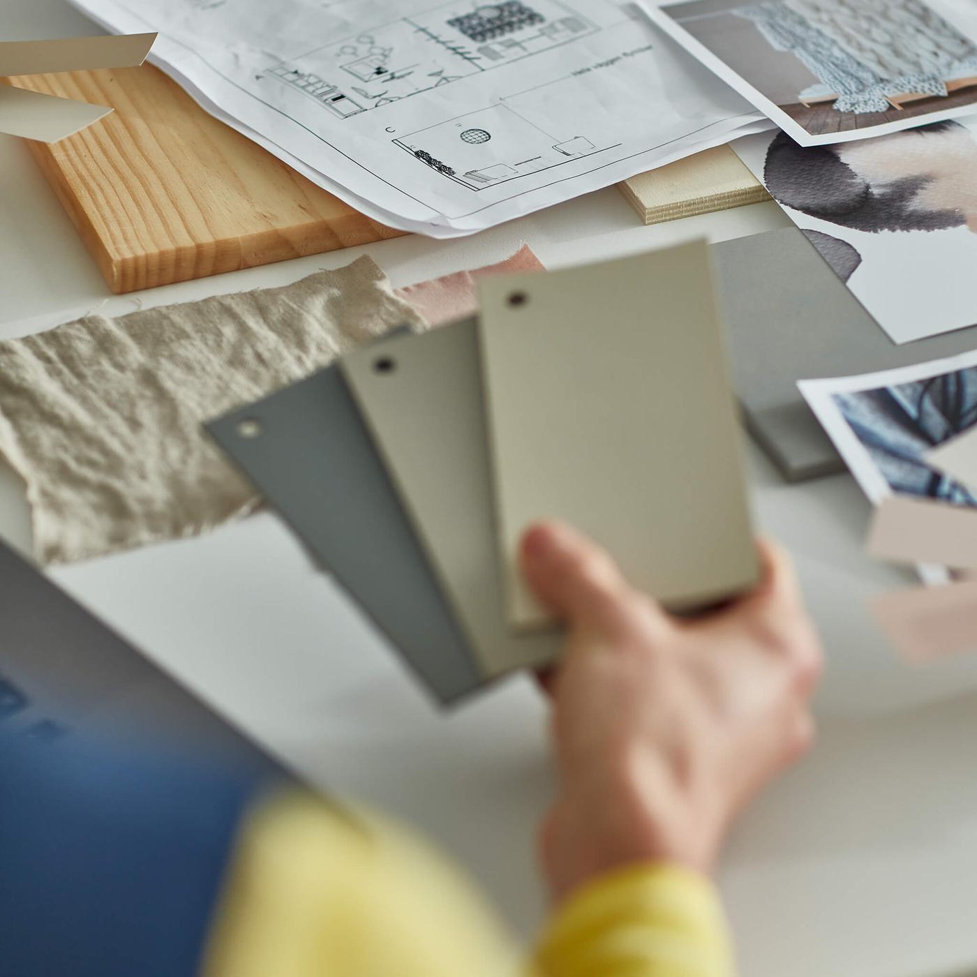 person holding color swatches