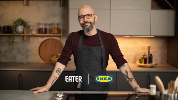 Person in a kitchen wearing a dark apron, standing behind a counter with Eater and IKEA logos.