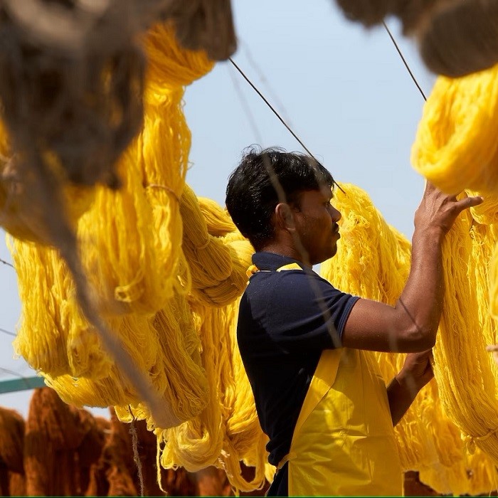 Person is drying the yellow coloured yarns