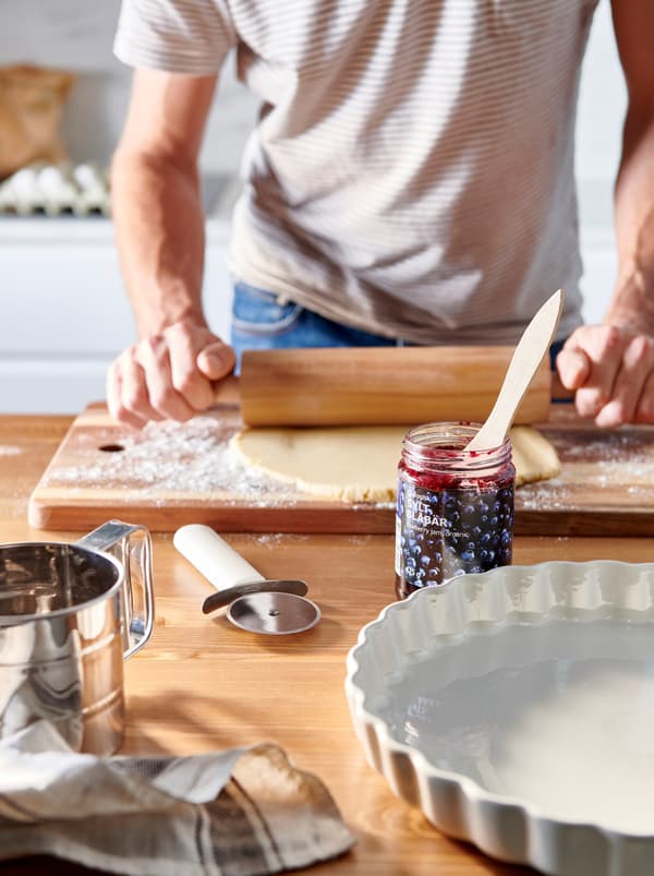 Person making pie dough in the kitchen.