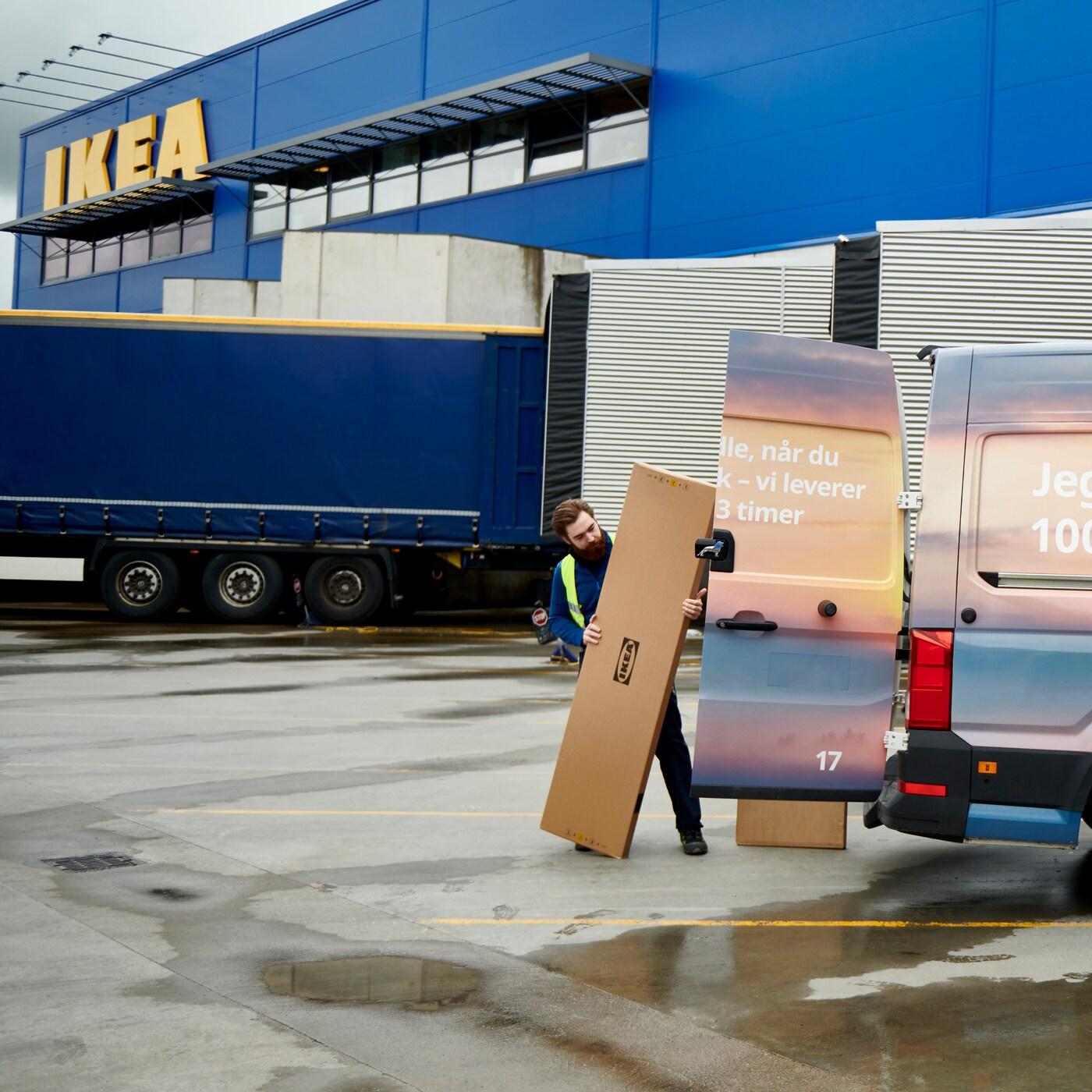 Person putting large parcel into van