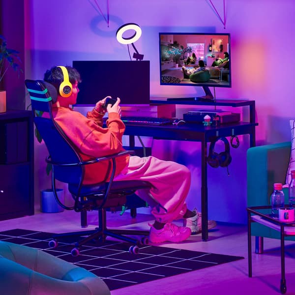 Person sitting at desk with controller