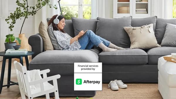 Person sitting on couch shopping on their phone