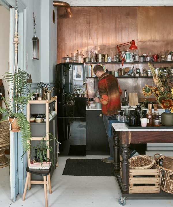 Photo de Łukasz debout dans la cuisine remplissant un flacon.