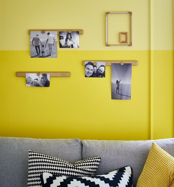 Photos are posted to magnetic knife racks painted gold. 